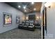 Cozy home theater features plush seating, surround sound, and a large screen for immersive movie nights at 9433 Wallace Pond Dr, Huntersville, NC 28078