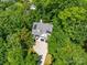 Aerial view of the house showcasing lush trees surrounding the property and a large driveway at 9712 Worley Dr, Charlotte, NC 28215