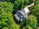 Aerial view of a house featuring a gray roof, surrounded by lush, mature trees at 9712 Worley Dr, Charlotte, NC 28215