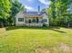 Expansive backyard featuring a well-maintained lawn and a view of the home's porch at 9712 Worley Dr, Charlotte, NC 28215