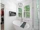 Luxurious bathroom with a standalone tub, modern lighting, and a view of the backyard at 9712 Worley Dr, Charlotte, NC 28215