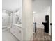 Bright bathroom features double vanity, large mirrors, shower and hall access to an entertainment area at 9712 Worley Dr, Charlotte, NC 28215