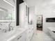 Bright bathroom with double vanity, modern fixtures, and a view into the walk-in closet at 9712 Worley Dr, Charlotte, NC 28215