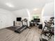 Multi purpose bonus room with a large window, treadmill, and workstation at 9712 Worley Dr, Charlotte, NC 28215