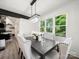 Elegant dining room with a modern chandelier and expansive windows for natural lighting at 9712 Worley Dr, Charlotte, NC 28215