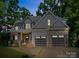 Charming two-story home with a welcoming front porch and a two-car garage at 9712 Worley Dr, Charlotte, NC 28215