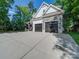 Exterior view highlighting the side of the house, featuring a two-car garage and a long driveway at 9712 Worley Dr, Charlotte, NC 28215