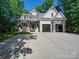 Exterior view showcasing the front of the home with a spacious driveway and a two-car garage at 9712 Worley Dr, Charlotte, NC 28215