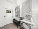 Bright foyer with wood floor, bench, decor table, and front door at 9712 Worley Dr, Charlotte, NC 28215