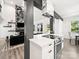 Open-concept kitchen with stainless steel oven, marble range hood, and bright white cabinets at 9712 Worley Dr, Charlotte, NC 28215