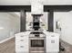 Modern kitchen featuring white cabinets, marble accents, and stainless steel oven in an open concept layout at 9712 Worley Dr, Charlotte, NC 28215