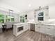 Well-lit kitchen with stainless steel appliances, marble countertops, and dining area at 9712 Worley Dr, Charlotte, NC 28215