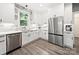 Charming kitchen with stainless steel appliances, white cabinets, and stylish marble countertops at 9712 Worley Dr, Charlotte, NC 28215