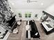 Stunning living room boasting a fireplace with a marble surround and elegant black sectional sofa at 9712 Worley Dr, Charlotte, NC 28215