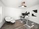 Bright office with dark wood floors, ceiling fan, unique chair, monitor setup, and abstract art at 9712 Worley Dr, Charlotte, NC 28215