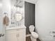 Stylish powder room with modern fixtures, marble accent wall, and striped wallpaper at 9712 Worley Dr, Charlotte, NC 28215