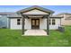 Backyard patio with a covered entryway and a well-maintained grassy lawn at 9924 Manor Vista Trl, Kannapolis, NC 28027