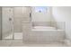 Bathroom showcasing a glass shower and separate tub with tile surround at 9924 Manor Vista Trl, Kannapolis, NC 28027