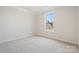 Bedroom features neutral carpet, white walls, large window and white trim at 9924 Manor Vista Trl, Kannapolis, NC 28027