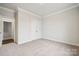 Bedroom showcasing neutral carpet, white trim, closet and access to hall at 9924 Manor Vista Trl, Kannapolis, NC 28027