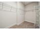 Walk-in closet with carpet, shelving racks, and neutral paint at 9924 Manor Vista Trl, Kannapolis, NC 28027