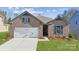 Charming brick home features a two-car garage, blue shutters, and well-manicured lawn at 9924 Manor Vista Trl, Kannapolis, NC 28027