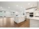 Open-concept kitchen with island, stainless steel appliances, and seamless flow to living area at 9924 Manor Vista Trl, Kannapolis, NC 28027