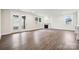 Bright living room features a fireplace, wood floors, and access to the outdoors at 9924 Manor Vista Trl, Kannapolis, NC 28027