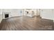 Open-concept living room features a fireplace, wood floors, and seamless flow to the kitchen at 9924 Manor Vista Trl, Kannapolis, NC 28027