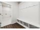 Mudroom with hooks, bench seating, cubbies and wood flooring with access to laundry room at 9924 Manor Vista Trl, Kannapolis, NC 28027