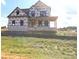 New home construction featuring brick foundation and covered porch awaiting finishing touches at Lot 100 Coppergate Dr, Salisbury, NC 28147