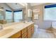 Bright bathroom with double vanity, bathtub, and ample natural light at 1066 Iveywood Nw Pl, Concord, NC 28027