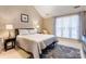 Cozy bedroom with neutral tones, large window, and comfortable furnishings at 1066 Iveywood Nw Pl, Concord, NC 28027