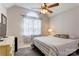 Comfortable bedroom featuring a queen-sized bed, neutral decor, and a window with decorative curtains at 1066 Iveywood Nw Pl, Concord, NC 28027