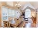 Dining room showcases a long dining table, chandelier, and view into the adjacent living area at 1066 Iveywood Nw Pl, Concord, NC 28027