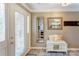 Bright entry featuring a white door with decorative glass, tiled floors and a bench with mirrors at 1066 Iveywood Nw Pl, Concord, NC 28027