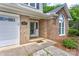 Close-up of the home's front door, showcasing the brick facade and decorative glass window feature at 1066 Iveywood Nw Pl, Concord, NC 28027