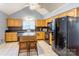 Bright kitchen featuring wooden cabinets, an island with seating, and black appliances at 1066 Iveywood Nw Pl, Concord, NC 28027