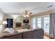 Relaxing living room featuring a brick fireplace and access to an outdoor deck at 1066 Iveywood Nw Pl, Concord, NC 28027