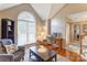 Cozy living room featuring hardwood floors, large windows, a comfortable chair, and natural lighting at 1066 Iveywood Nw Pl, Concord, NC 28027
