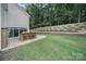 Backyard features an outdoor bar area, patio seating, and a lush lawn, perfect for outdoor entertaining and relaxation at 11216 Preservation Ln, Charlotte, NC 28278