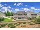 Backyard of home featuring a patio, lush landscaping and retaining wall at 11216 Preservation Ln, Charlotte, NC 28278