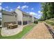Backyard featuring a stone patio with a built-in table and seating area at 11216 Preservation Ln, Charlotte, NC 28278