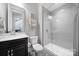 Modern bathroom featuring a glass-enclosed shower, gray subway tile, sleek vanity with marble countertop, and stylish fixtures at 11216 Preservation Ln, Charlotte, NC 28278
