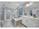 Elegant bathroom featuring a soaking tub, double vanities, walk-in shower, and a view to a spacious walk-in closet at 11216 Preservation Ln, Charlotte, NC 28278
