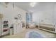 Charming Bedroom featuring neutral decor, a crib, a comfortable chair, and coordinated hot air balloon wall decorations at 11216 Preservation Ln, Charlotte, NC 28278