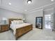Bright bedroom with a wooden bed, two side tables, and a doorway, creating a peaceful and inviting space at 11216 Preservation Ln, Charlotte, NC 28278