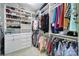 Organized walk-in closet with custom shelves, hanging racks, drawers, and dedicated space for shoes and accessories at 11216 Preservation Ln, Charlotte, NC 28278