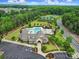 Aerial view of the community pool, clubhouse, tennis courts, and lush landscaping at 11216 Preservation Ln, Charlotte, NC 28278