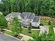 Beautiful home featuring a covered front porch, manicured lawn and mature trees at 11216 Preservation Ln, Charlotte, NC 28278